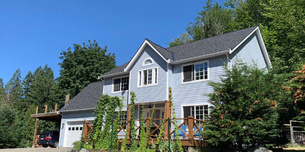 blue house with new black shingles
